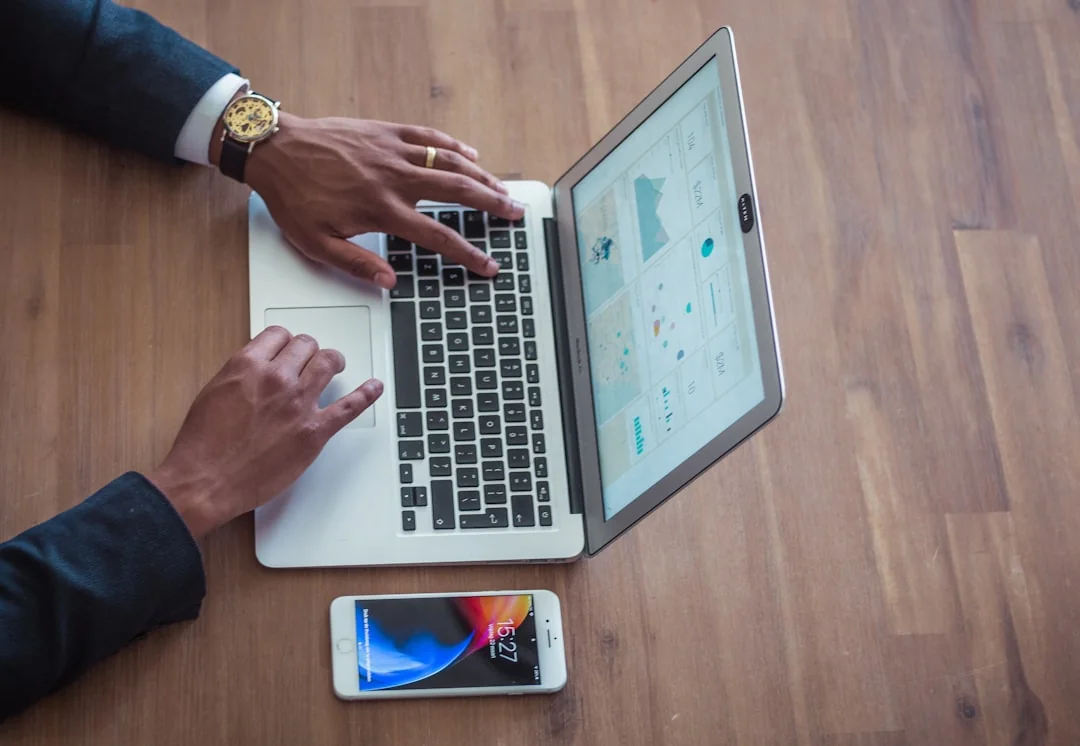 who-we-are A person working on a laptop, with a stylish tote bag close by in a relaxed setting.